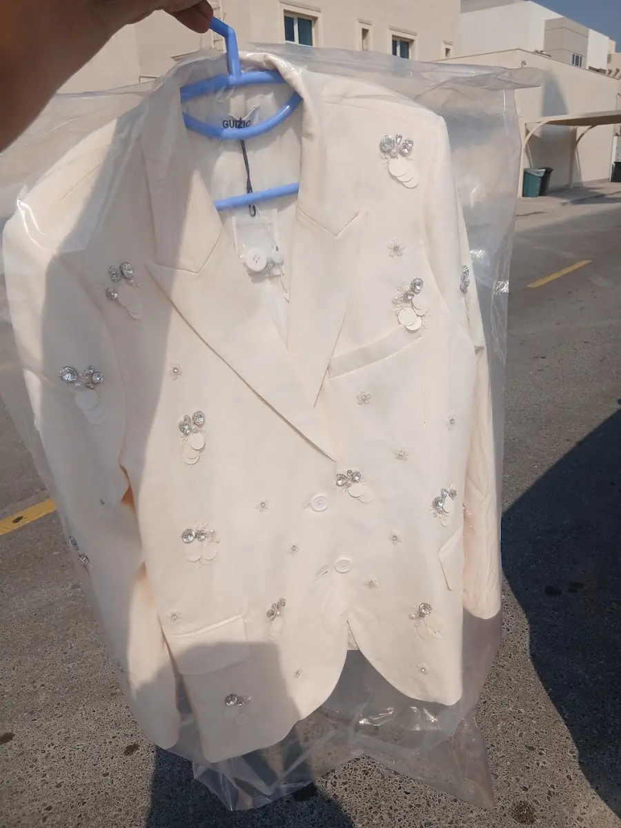 An ivory embellished jacket finished in the workroom